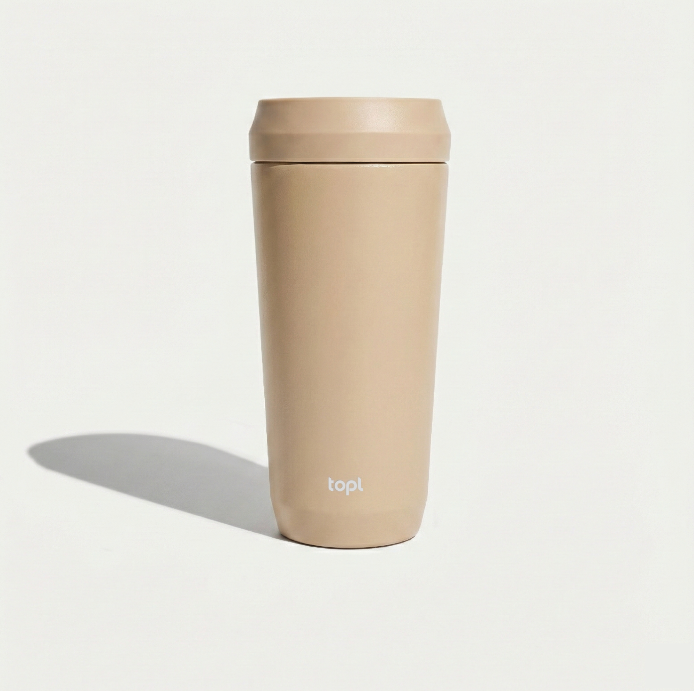Beige tumbler with 'top!' branding on a light gray background
